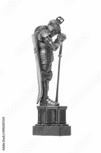 Silver figurine of a medieval knight isolated on white background