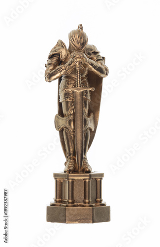 Golden figurine of a medieval knight isolated on white background