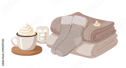 A warm cup of whipped cream coffee stands next to a scented candle and a stack of cozy knitted blankets topped with wool socks on a white background.