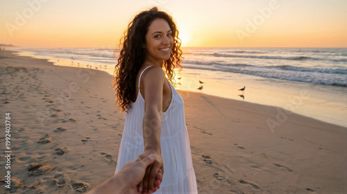 Woman holding hand leading partner along sandy beach at sunset. Young girl pulling friend towards ocean waves during golden hour. Romantic summer travel, vacation, discovery and lifestyle.