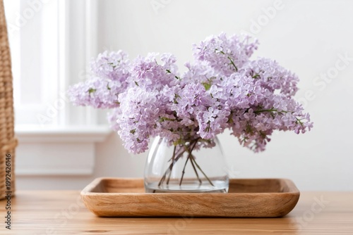 Colorful Lilac Flowers in Glass Vase on Wooden Tray Beside Window During Daylight
