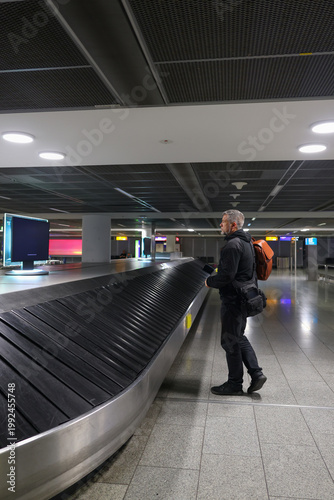 Man retrieving baggage at airport, arrival, transportation and travel lifestyle.