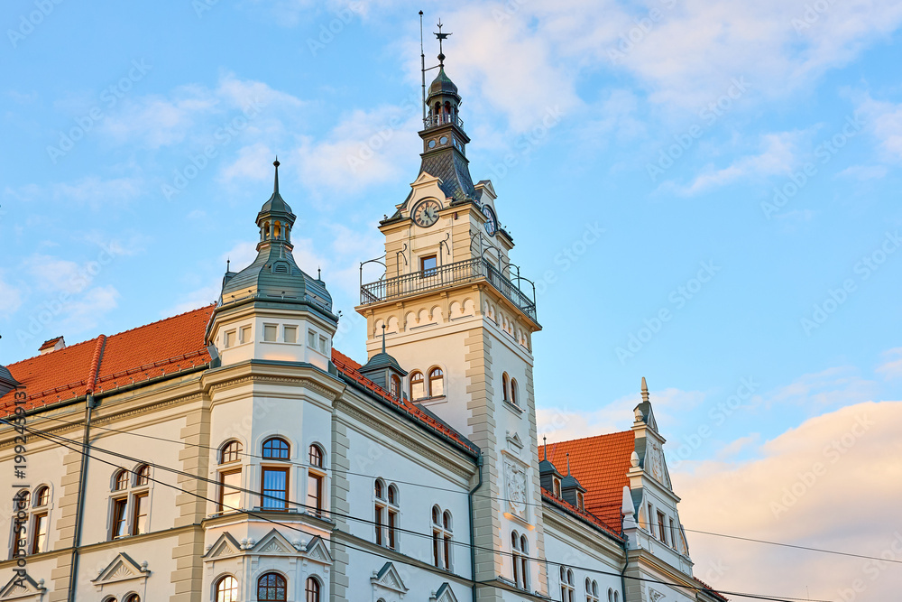 Obraz premium Historic european building with clock tower against blue sky