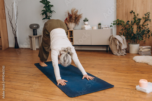 Canvastavla Senior woman practices new yoga pose in bright home studio