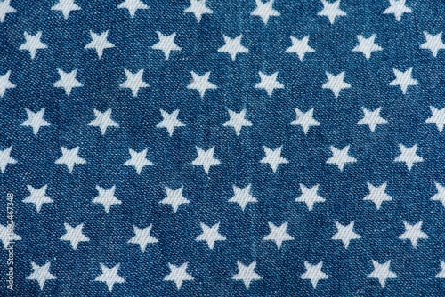Fotografie Old blue denim and printed star pattern background.