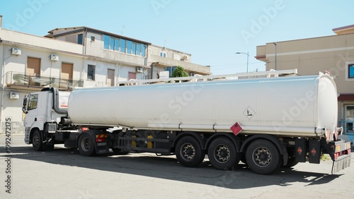 Photography Tanker truck unloading fuel at gas station