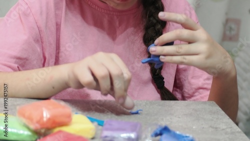 Little girls sculpt figurines crafts from air plasticine, modeling dough. Online lessons in tablet. Children's creativity hobby developing activities, training, learn of fine motor skills of hands.