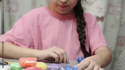 Little girls sculpt figurines crafts from air plasticine, modeling dough. Online lessons in tablet. Children's creativity hobby developing activities, training, learn of fine motor skills of hands.