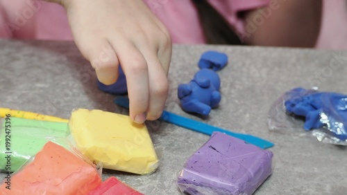 Little girls sculpt figurines crafts from air plasticine, modeling dough. Online lessons in tablet. Children's creativity hobby developing activities, training, learn of fine motor skills of hands.