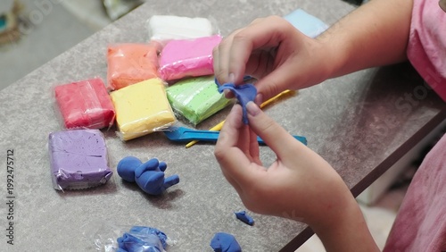 Little girls sculpt figurines crafts from air plasticine, modeling dough. Online lessons in tablet. Children's creativity hobby developing activities, training, learn of fine motor skills of hands.