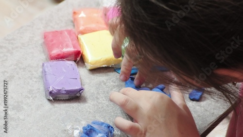Little girls sculpt figurines crafts from air plasticine, modeling dough. Online lessons in tablet. Children's creativity hobby developing activities, training, learn of fine motor skills of hands.
