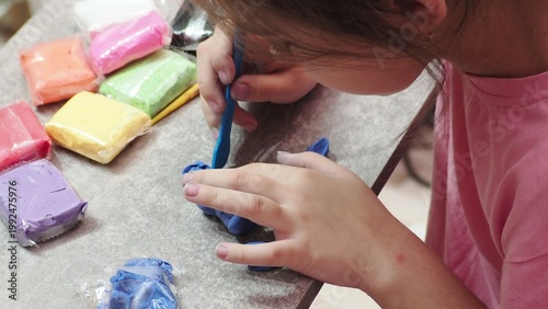 Little girls sculpt figurines crafts from air plasticine, modeling dough. Online lessons in tablet. Children's creativity hobby developing activities, training, learn of fine motor skills of hands.