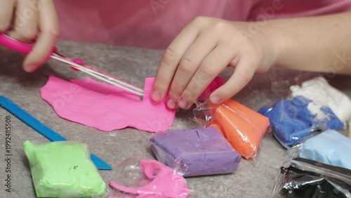 Little girls sculpt figurines crafts from air plasticine, modeling dough. Online lessons in tablet. Children's creativity hobby developing activities, training, learn of fine motor skills of hands.