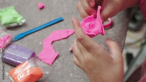 Little girls sculpt figurines crafts from air plasticine, modeling dough. Online lessons in tablet. Children's creativity hobby developing activities, training, learn of fine motor skills of hands.