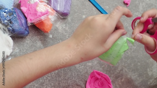 Little girls sculpt figurines crafts from air plasticine, modeling dough. Online lessons in tablet. Children's creativity hobby developing activities, training, learn of fine motor skills of hands.