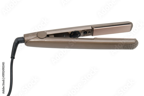 Electric hair straightener isolated on transparent background. Professional ceramic flat iron for hair styling and smoothing. Beauty care electronic device for salon and home hair treatment.