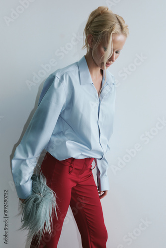 Portrait of woman in blue shirt studio background