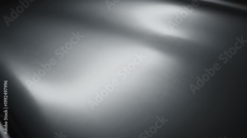 Abstract metallic background with light reflections and shadows.