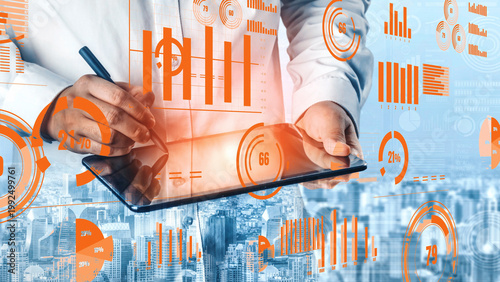 Fotografía A business analyst engages with a tablet, analyzing dynamic data visualizations