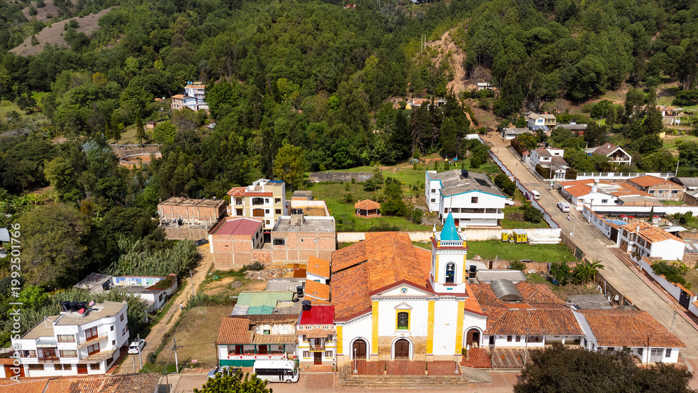 Fototapeta premium Tinjacá, Boyacá - Colombia. March 10, 2026. Panoramic drone view of the town's main church.