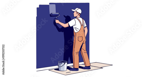 Painter in overalls applying dark blue paint to wall with roller
