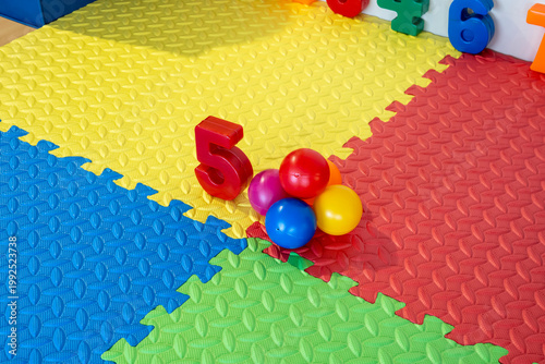 Obraz na plátne Number five in red and colorful balls on a foam playmat