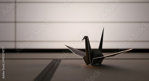Black origami crane on textured surface against neutral background