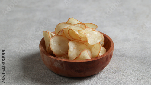 Bilde på lerret Cassava chips, a traditional Indonesian snack, are made from thin slices of cass