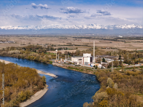 Aerial view of the Enrico Fermi Nuclear Power Plant and the Po River with the snow-capped Alps in the background Trino, Piemonte, Italy.