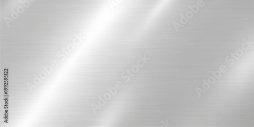 Polished silver brushed metal texture background with a shiny metallic stainless steel plate surface and light reflection pattern on a gray aluminium material backdrop