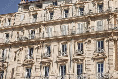 Typical Haussmann-style residential building in Marseille, France, from below, shuttered windows, illustrating real estate in marseille and classic French property architecture.