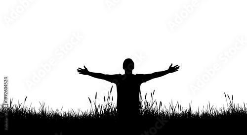 Silhouette of a man with arms outstretched in a field of grass.