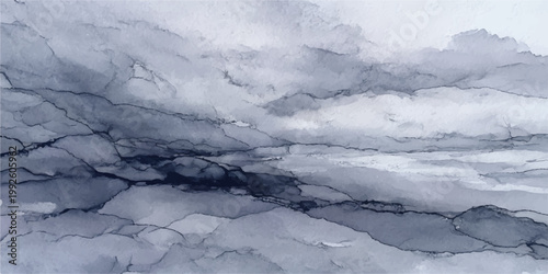 An aerial winter flight high above snow-covered mountains reveals a cold landscape of ice on the river and lake under a blue cloudy sky