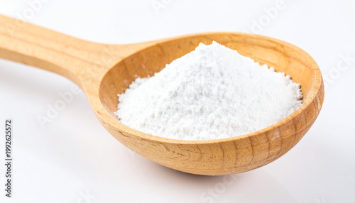 A wooden spoon filled with a mound of fine white cornstarch on a white background
