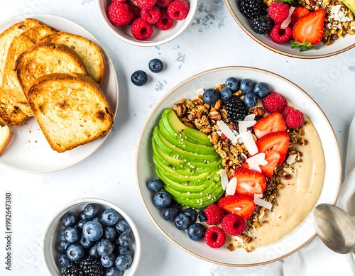 A delicious and healthy breakfast spread featuring a bowl of oatmeal with fresh fruit and granola