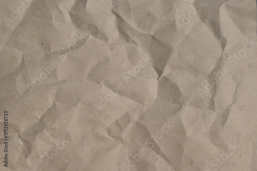 Greyish brown crumpled paper texture background, top view. 