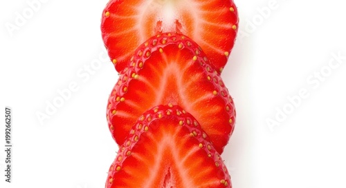 A close-up view of sliced strawberries showcasing their vibrant red interior and tiny seeds isolated on white background