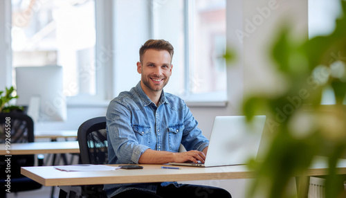 Freelancer smiling man sitting laptop office occupation technology workplace lifestyle working person professional business caucasian portrait computer worker