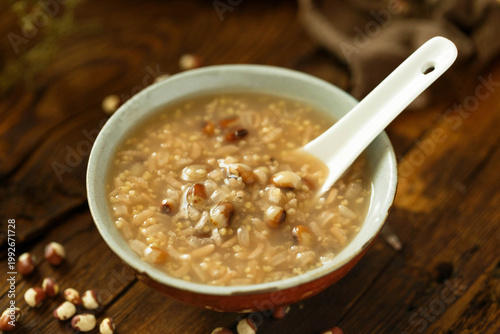 Tableau sur toile Warm multigrain porridge with rice and beans in bowl on rustic wooden table
