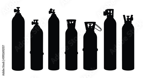 A collection of scuba tanks in a stark black silhouette