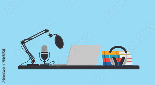 A desk with a laptop computer, microphone, headphones, and books for podcasting or recording.