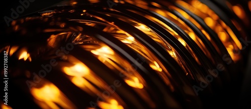 Abstract orange and yellow bokeh lights reflecting on dark parallel metallic lines background