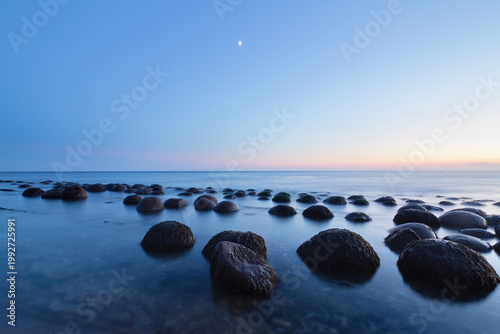 Mystical sunset over unique rock spheres at Bowling Ball Beach, California