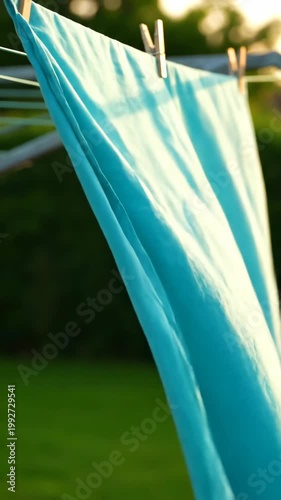 Turquoise sheet hanging on a clothesline