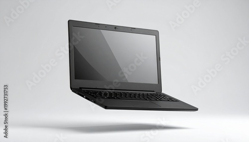 An elegant black laptop floating in a light, soft environment. The laptop appears modern and sleek, with its screen displayed 