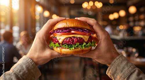 Plant-Based Vegan Burger with Beet “Bleeding” Patty Held in Hands, Gourmet Healthy Food Concept