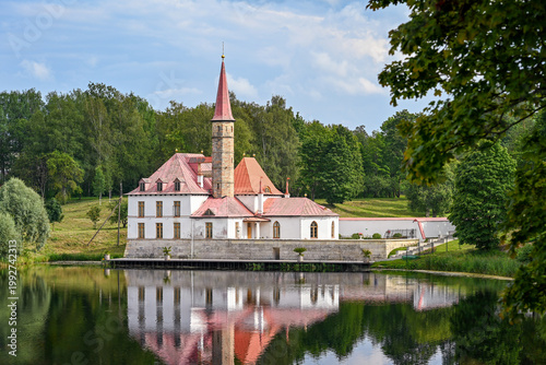 Reflection of the beautiful Priory Palace in the lake of a city park in Gatchina, Leningrad region of Russia