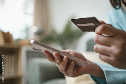 Billede på lærred User shopping online with credit card and smartphone using buy now pay later service, representing flexible payment options, digital finance, and modern e-commerce checkout experience