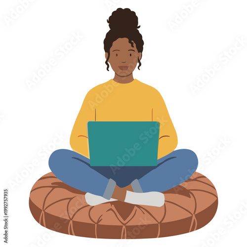 Woman sits cross-legged on a cushion with a laptop on her lap.