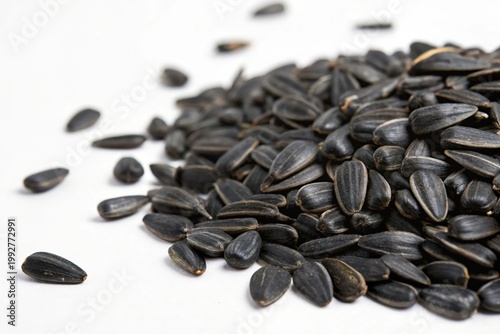 Black sunflower seeds scatter on pure white background